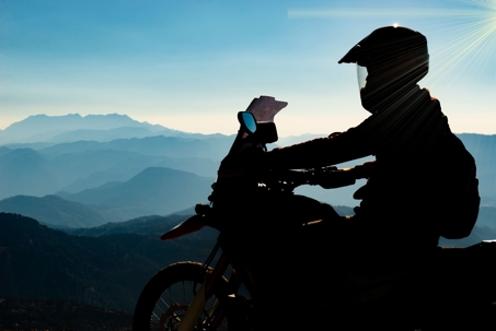 motorcycle rider riding through mountains